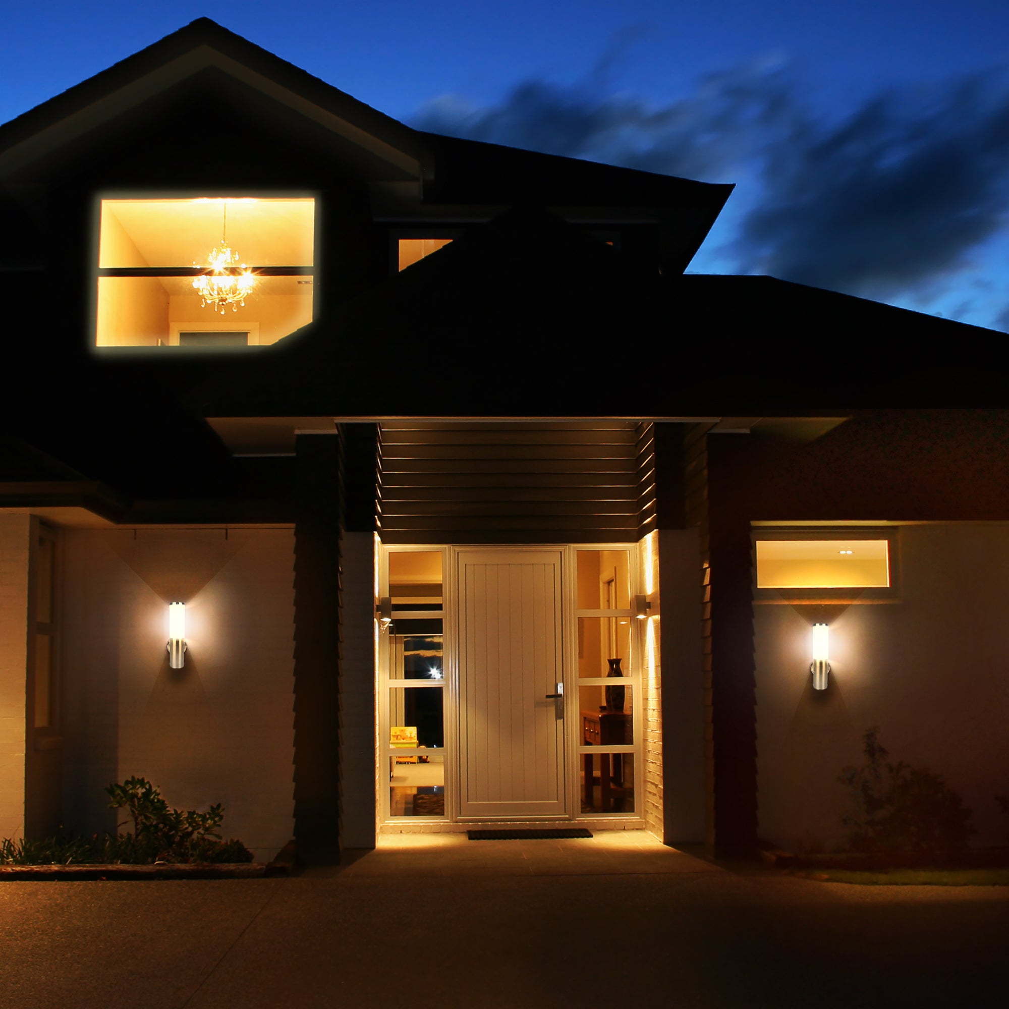 2 brushed nickel led wall sconces being used on the outside of a house