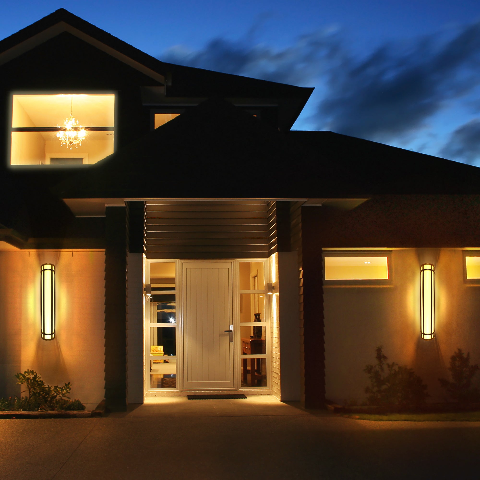 2 black led wall sconces being used on the outside of a house