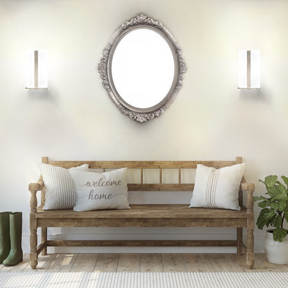 2 brushed nickel glass wall sconces being used on an entryway wall