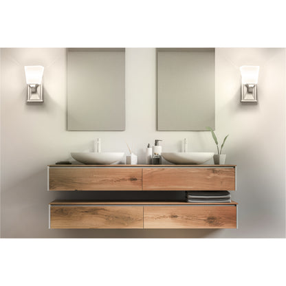 2 traditional led wall sconces being used on either side of a bathroom vanity